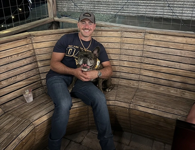 Dr. Dennis Rabinovich, veterinarian, posing with a dog